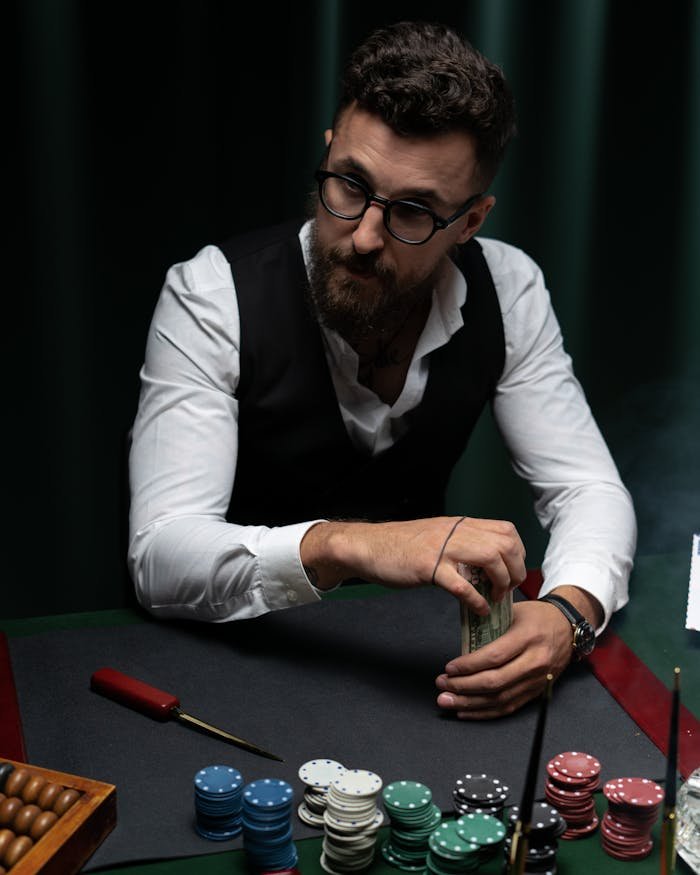 Man in Black Vest Holding Cash 